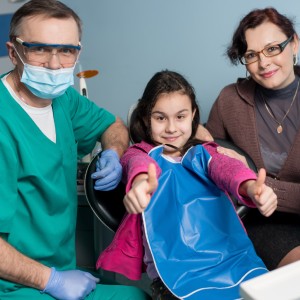 Pediatric Dentist Monrovia providing gentle dental care to a smiling child with parent support in a modern clinic